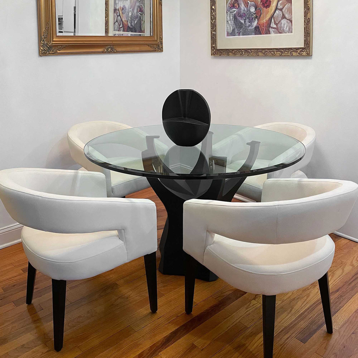 dining room with a glass table and white chairs