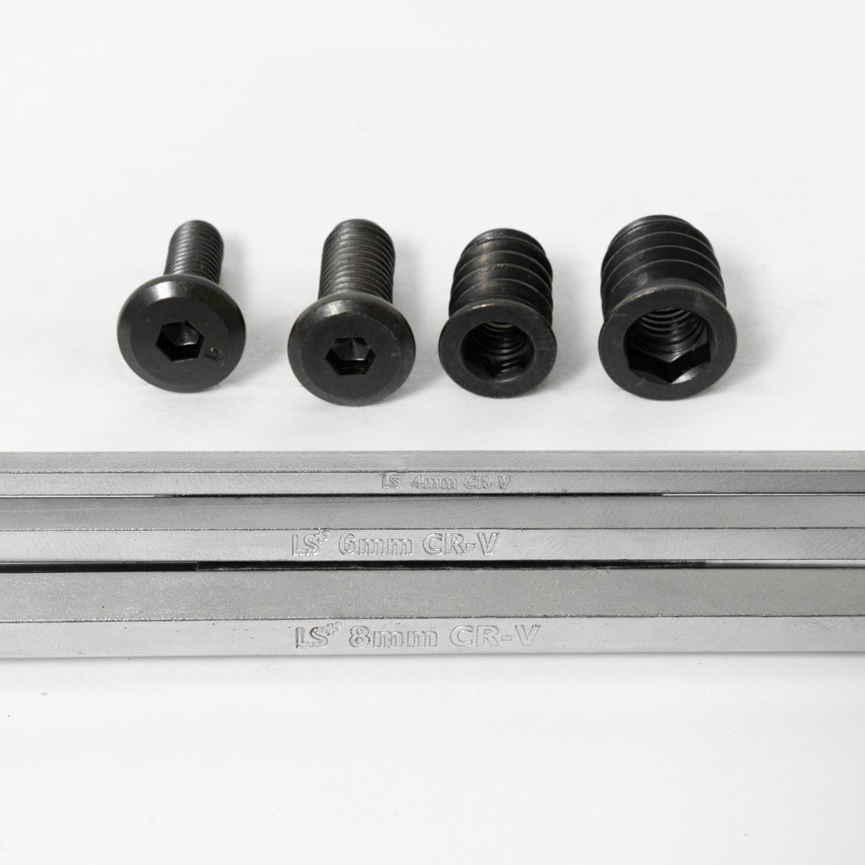 four black screws with a metal hex key below