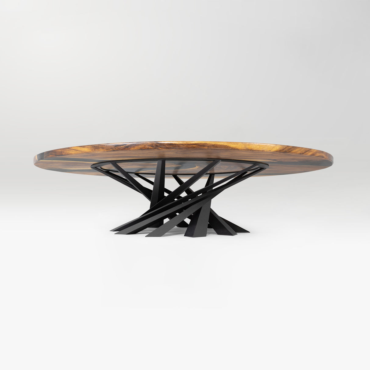 round wooden table with a black metal base on a white background