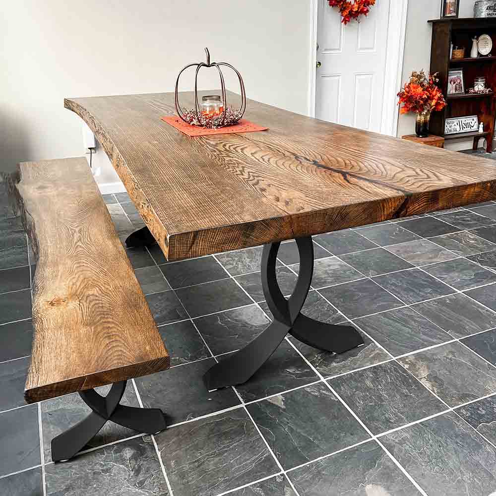 Dining table with curved design metal table legs under a solid wood top.