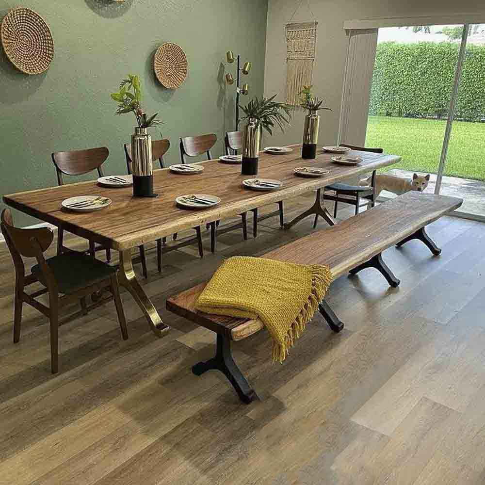 contemporary epoxy resin river table supported by wishbone bench legs