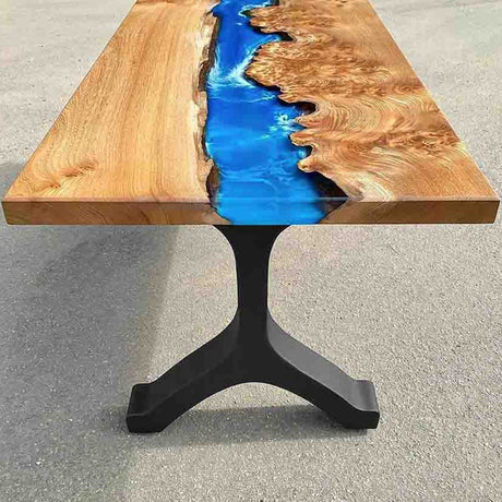 a wishbone-shape metal bench legs in black color with blue resin river on the table top