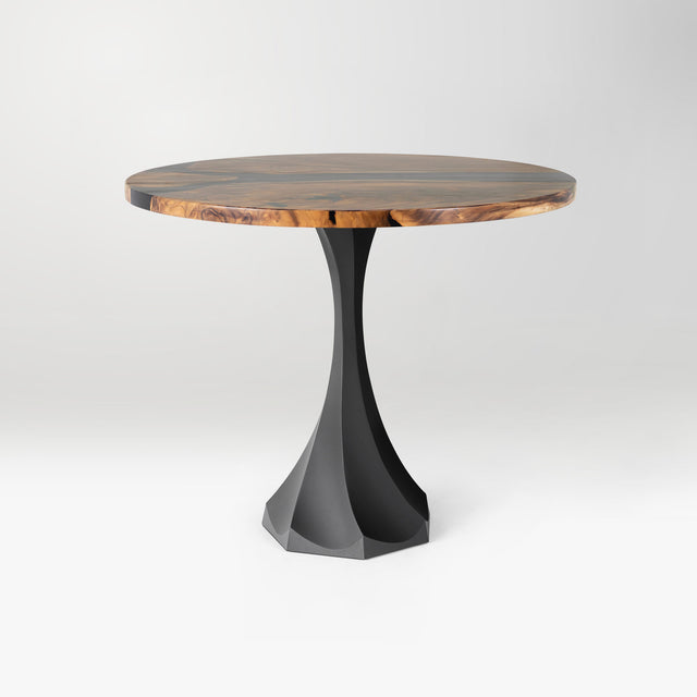 round wooden table with a black metal base