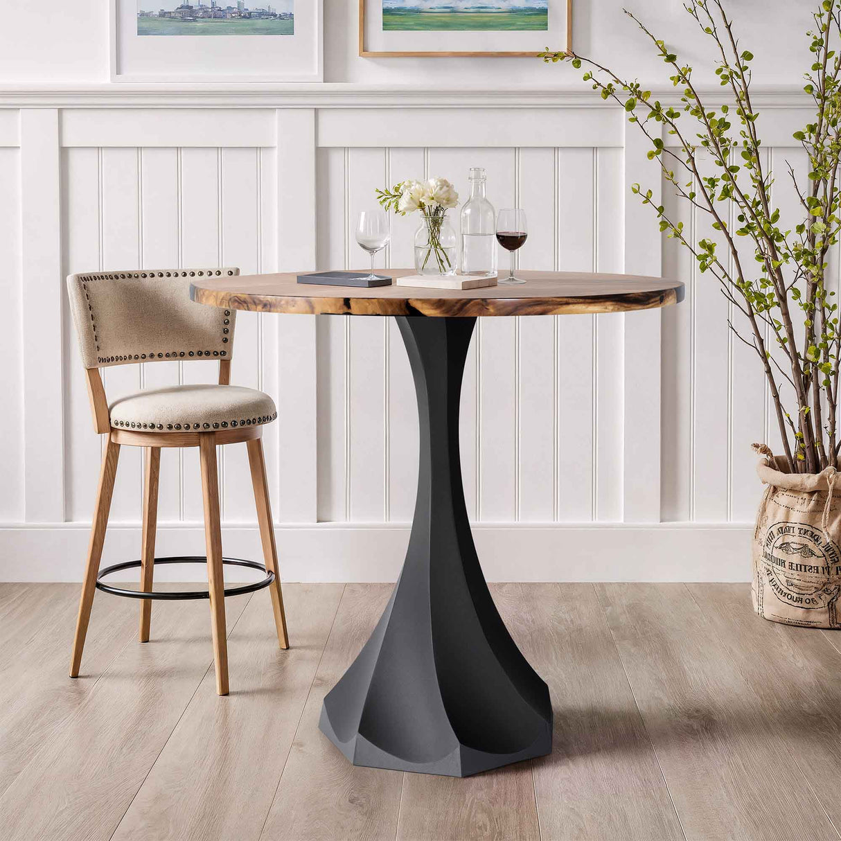round wooden table with a black metal base
