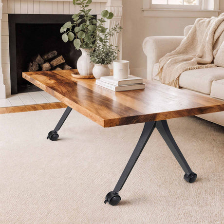 wooden table with wheels, white vase, and books against a white wall
