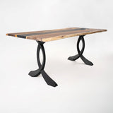 Industrial metal table legs supporting home office desk with workspace for laptops, monitors, and supplies