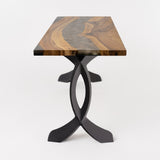 Angle view of small table featuring 423 Curva 28" H cruved design metal legs for table under a rustic wood slab.