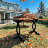 Outdoor epoxy dining table using curved design metal legs for table.