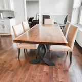 Modern dining table with curved metal table legs in bright, minimal interior.