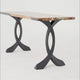 Video highlighting curved design metal table legs from multiple angles, showing their sculptural shape, stability, and support under wood table tops.