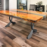 Live-edge wood table with black curved design table legs metal on patio.