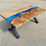 epoxy river table with natural wood slab and black wishbone legs