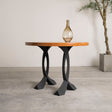 Round wood end table supported by 219 Curva 20" H cruved design metal end table legs in a modern studio setting.