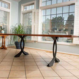 Glass top desk with mid-century metal table legs 28" H creating airy and spacious home office