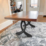 Metal table legs bottom view showing adjustable foot mechanism for leveling on tile, hardwood, or carpet